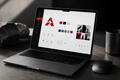 Brand Identity Kit Pro shown on a premium laptop mockup
